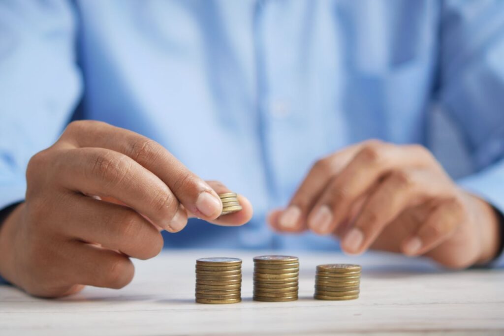 pexels-photo-9755376 Close-up of hands stacking gold coins, symbolizing financial growth and savings.